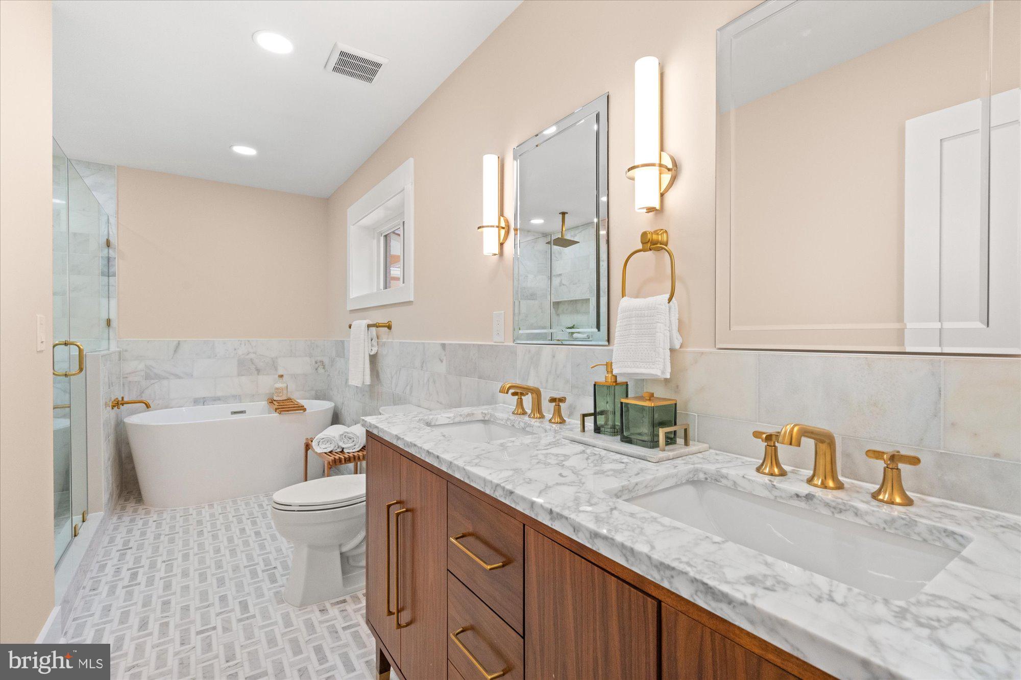 6125 Overlea Road Bethesda, MD 20816 - Photo 35 of 61 a bathroom with a granite countertop sink mirror vanity bathtub and a toilet