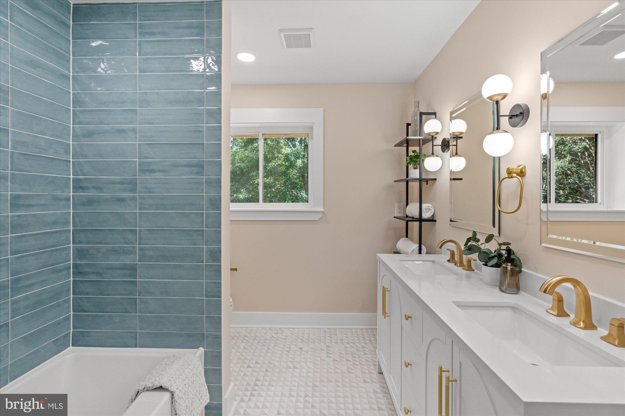 6125 Overlea Road Bethesda, MD 20816 - Photo 41 of 61 a bathroom with a double vanity sink a mirror and a shower
