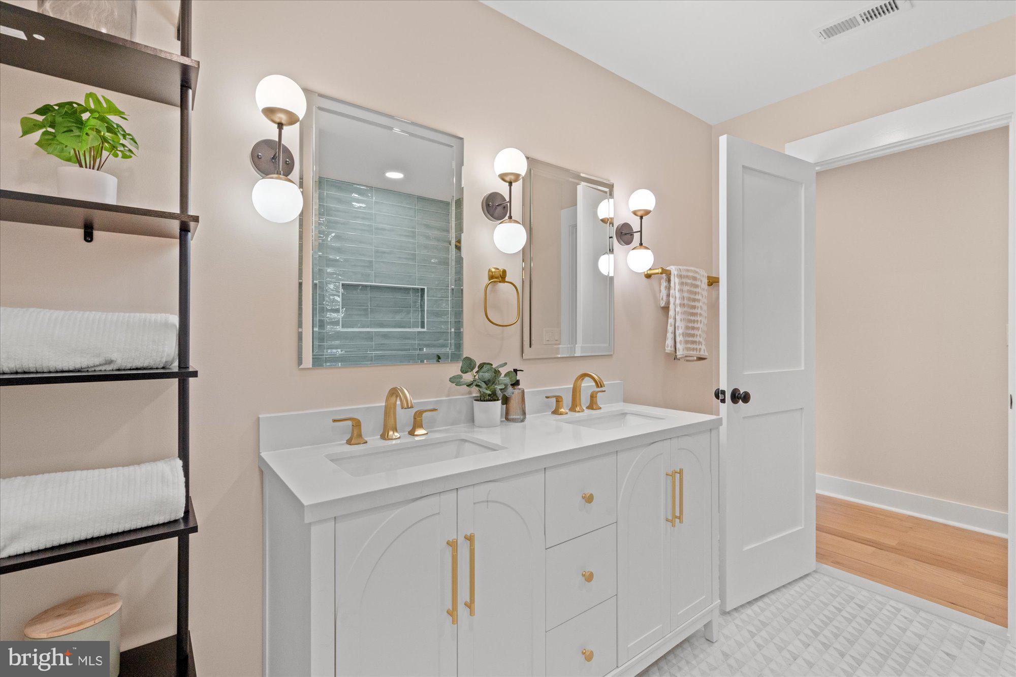 6125 Overlea Road Bethesda, MD 20816 - Photo 42 of 61 a bathroom with a double vanity sink mirror and double