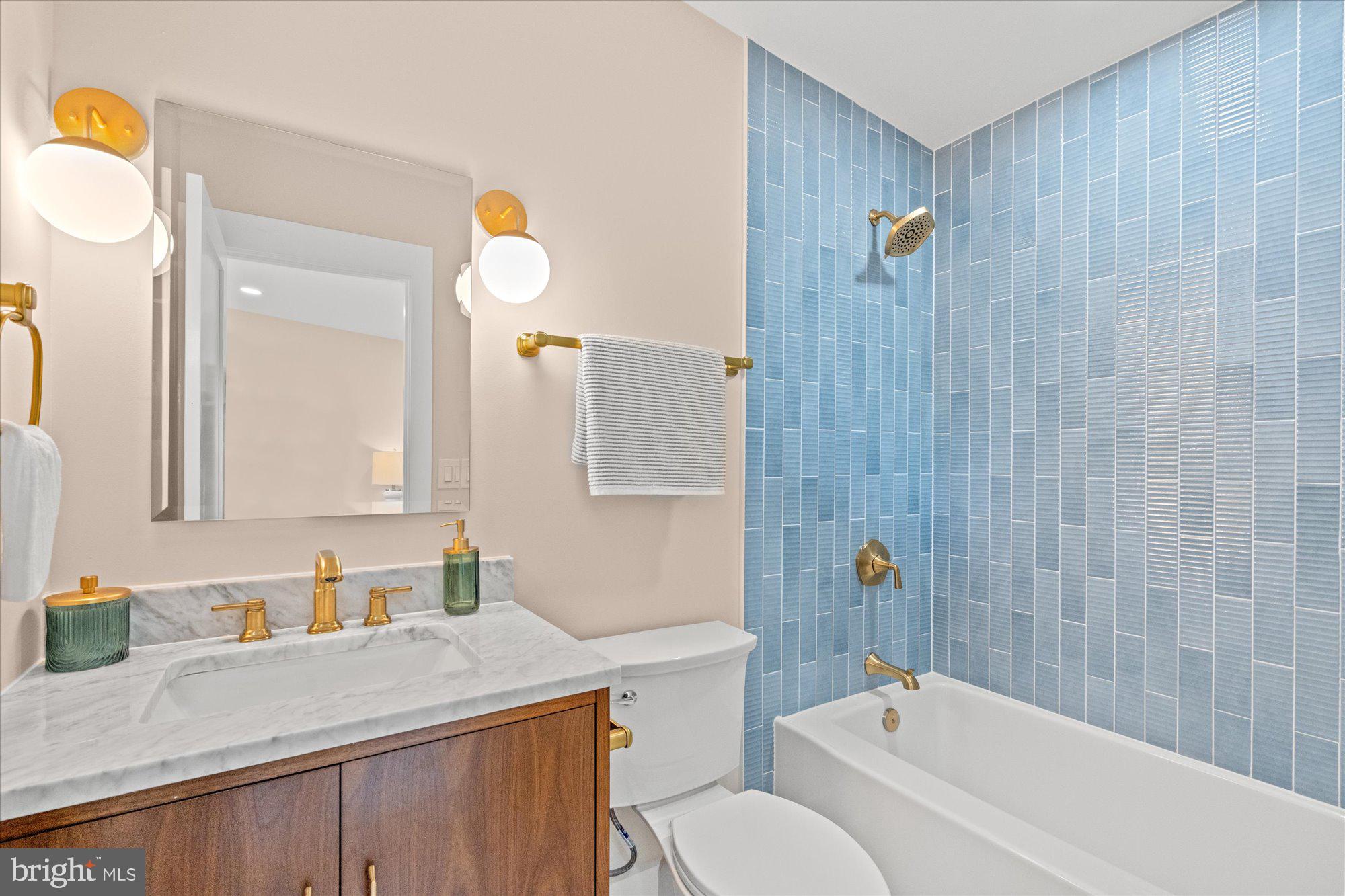 6125 Overlea Road Bethesda, MD 20816 - Photo 49 of 61 a bathroom with a granite countertop sink a toilet and shower