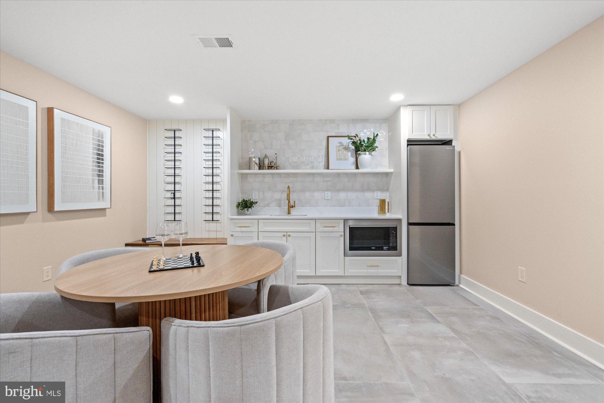 6125 Overlea Road Bethesda, MD 20816 - Photo 52 of 61 a kitchen with stainless steel appliances a sink and a refrigerator