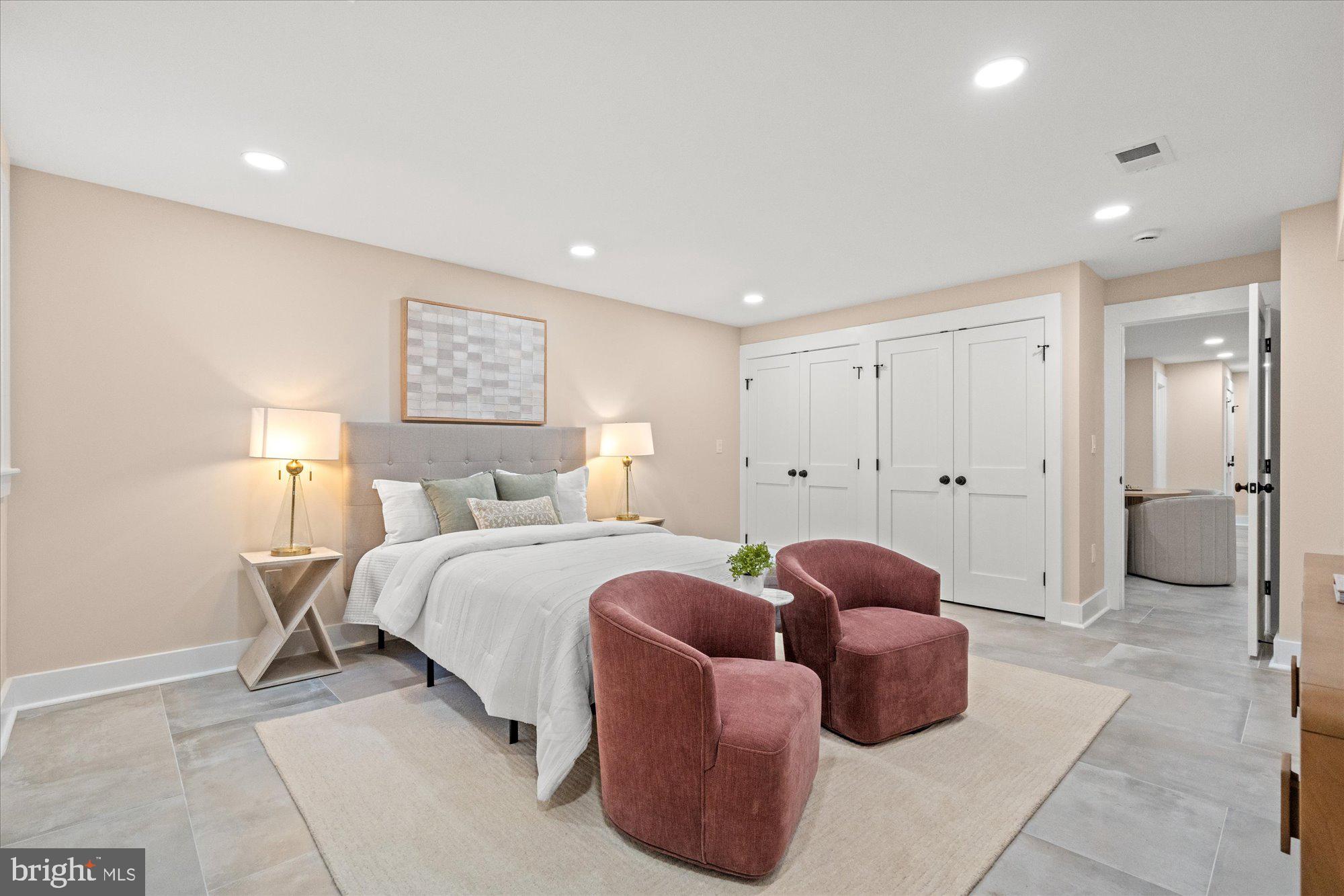 6125 Overlea Road Bethesda, MD 20816 - Photo 58 of 61 a spacious bedroom with a bed and a couch