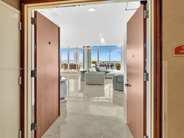 a large white kitchen with stainless steel appliances