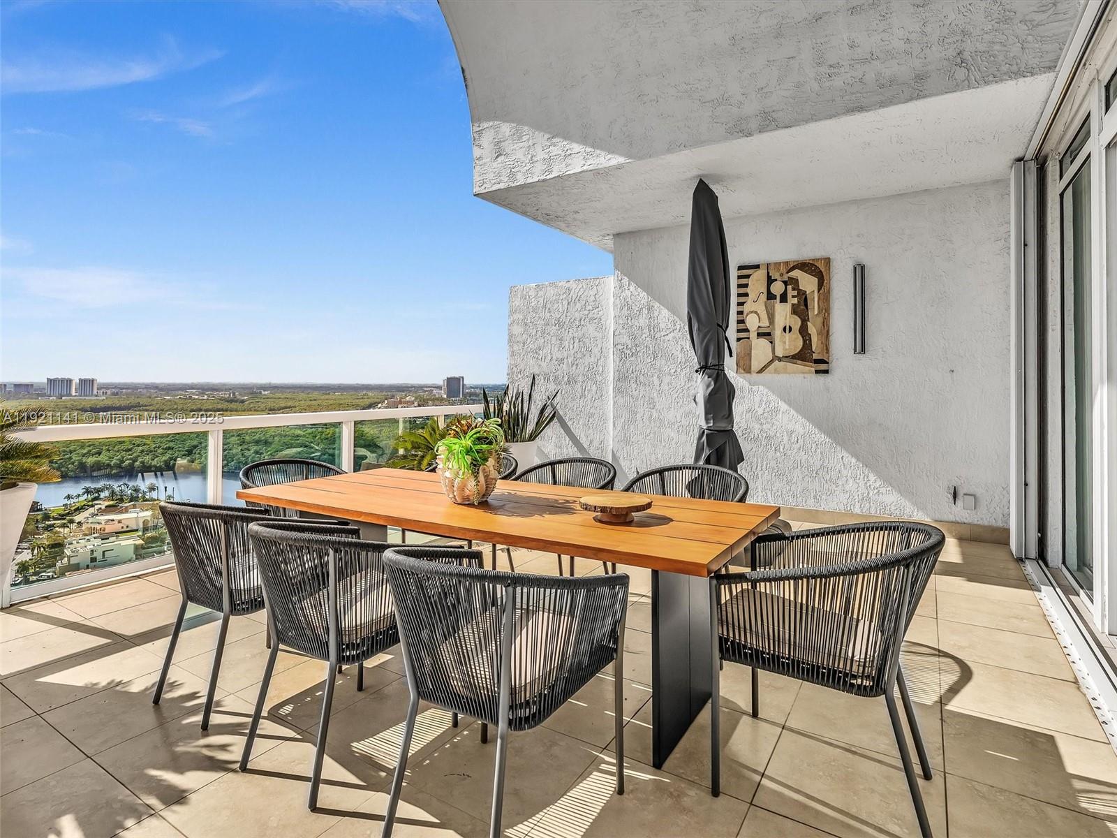 16500 Collins Avenue, Unit PH54 Sunny Isles Beach, FL 33160 - Photo 27 of 97 a outdoor view with a table and chairs