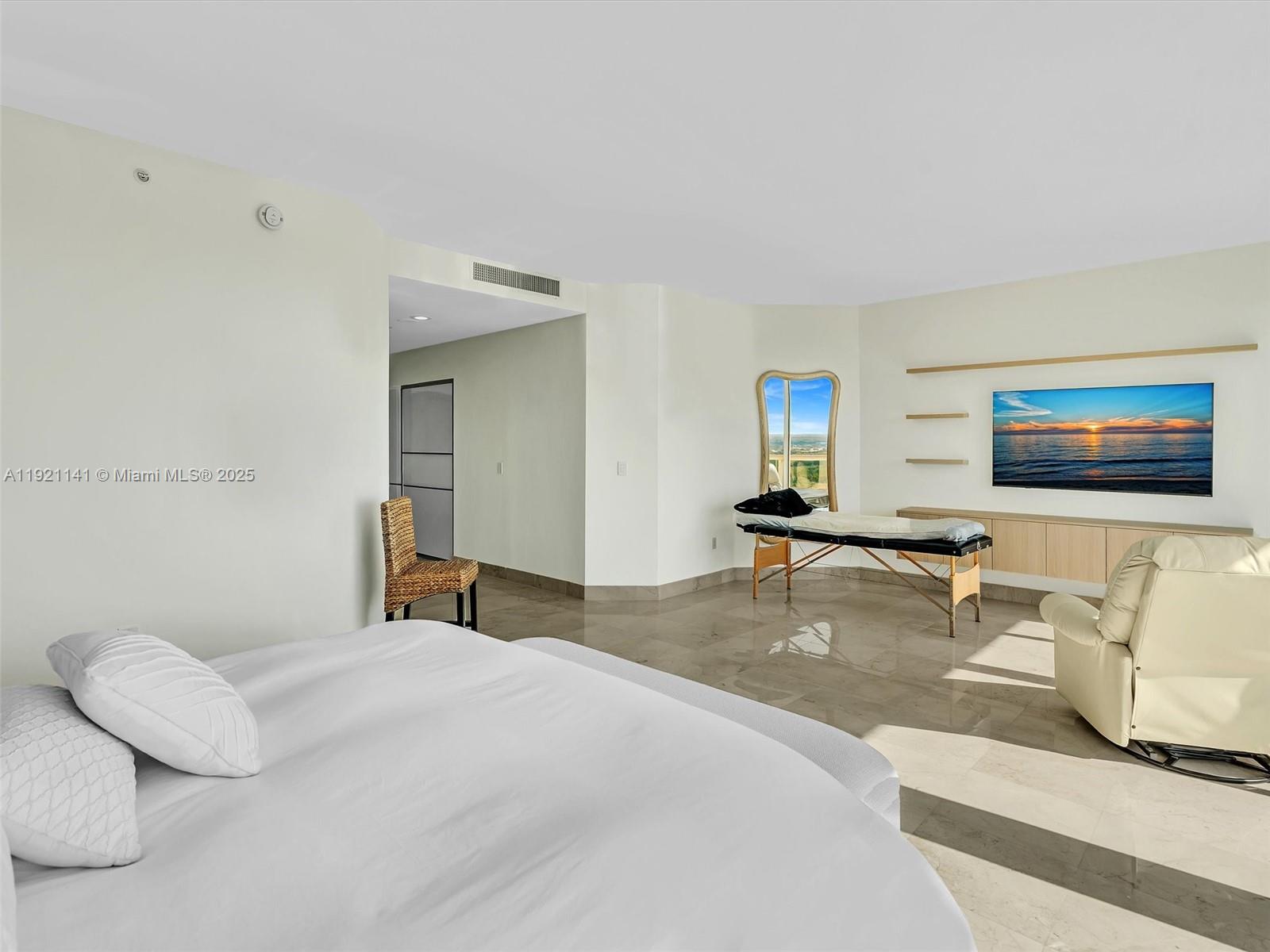 16500 Collins Avenue, Unit PH54 Sunny Isles Beach, FL 33160 - Photo 50 of 97 a bedroom with a bed and a flat screen tv