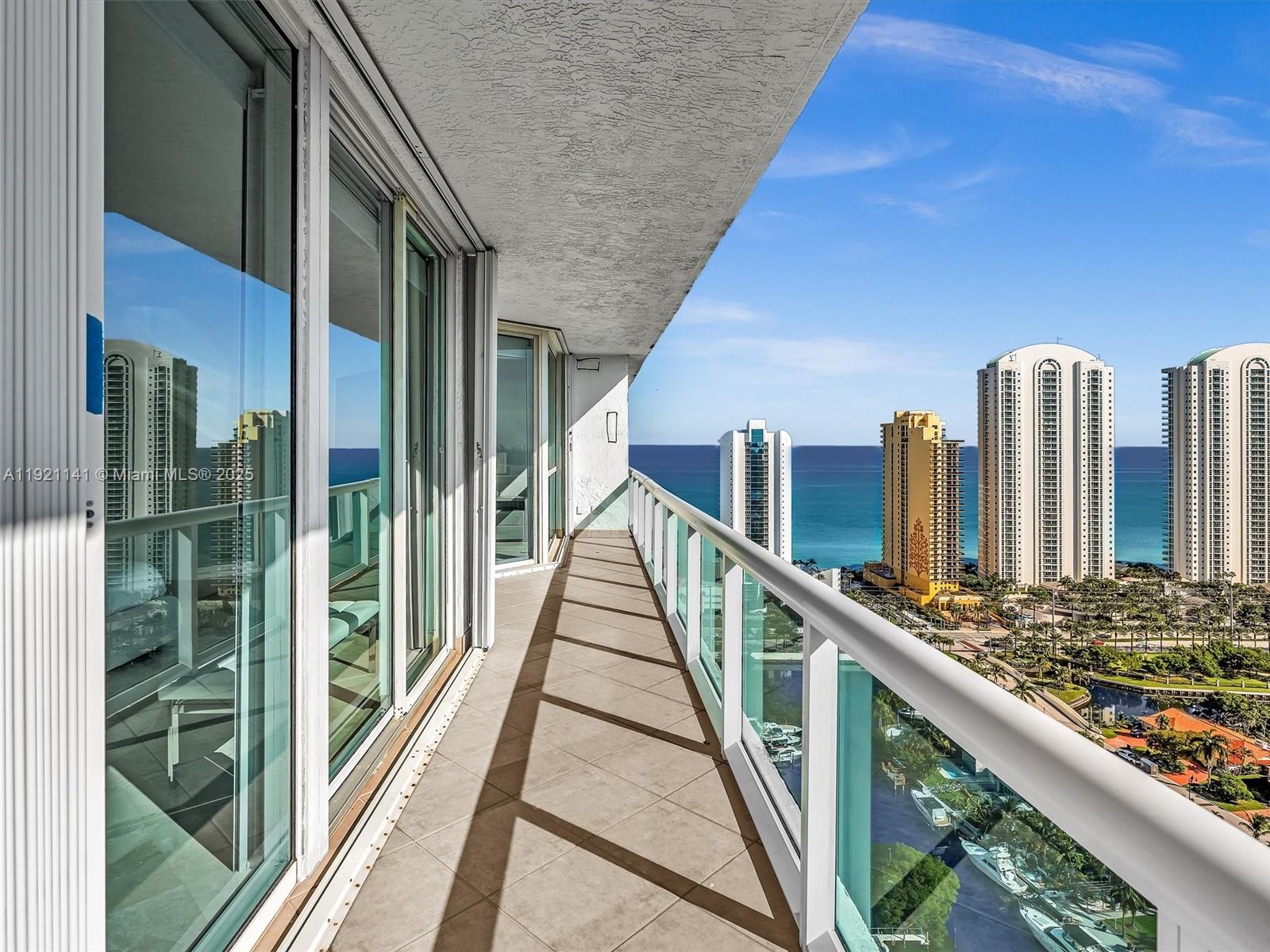 16500 Collins Avenue, Unit PH54 Sunny Isles Beach, FL 33160 - Photo 55 of 97 a balcony with wooden floor stairs and a large window
