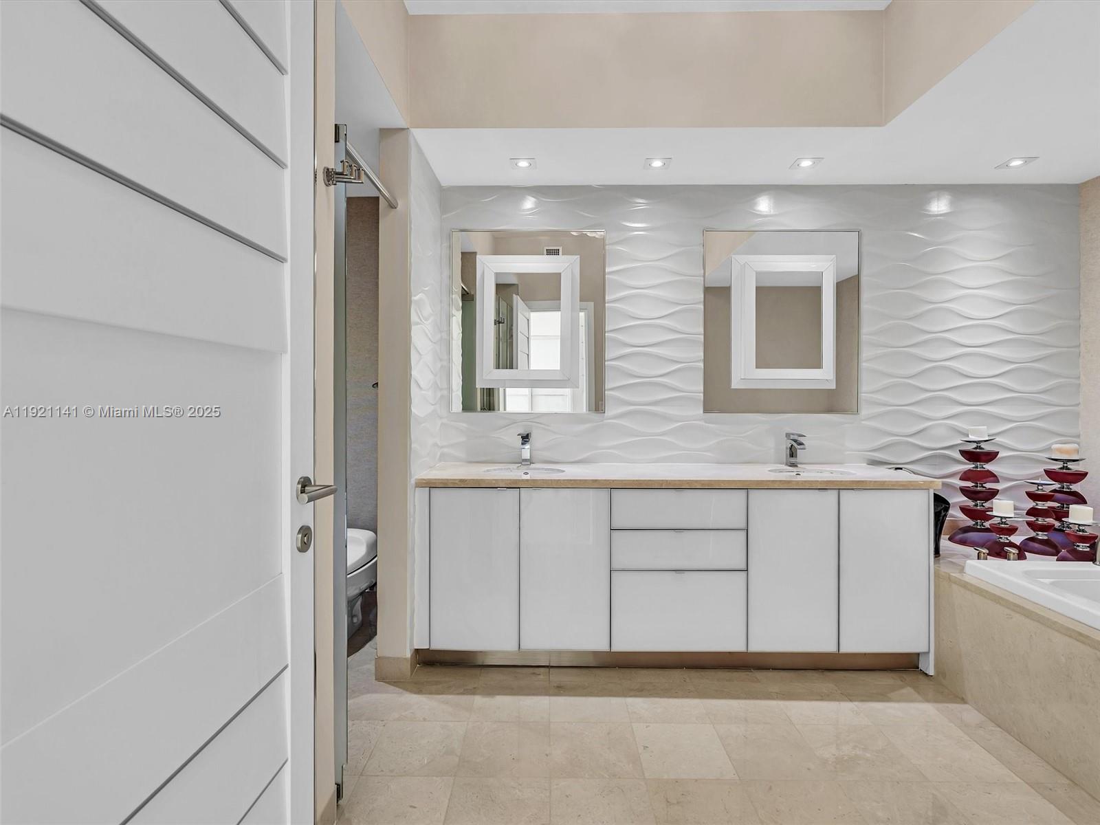 16500 Collins Avenue, Unit PH54 Sunny Isles Beach, FL 33160 - Photo 60 of 97 a bathroom with a sink a mirror and a shower