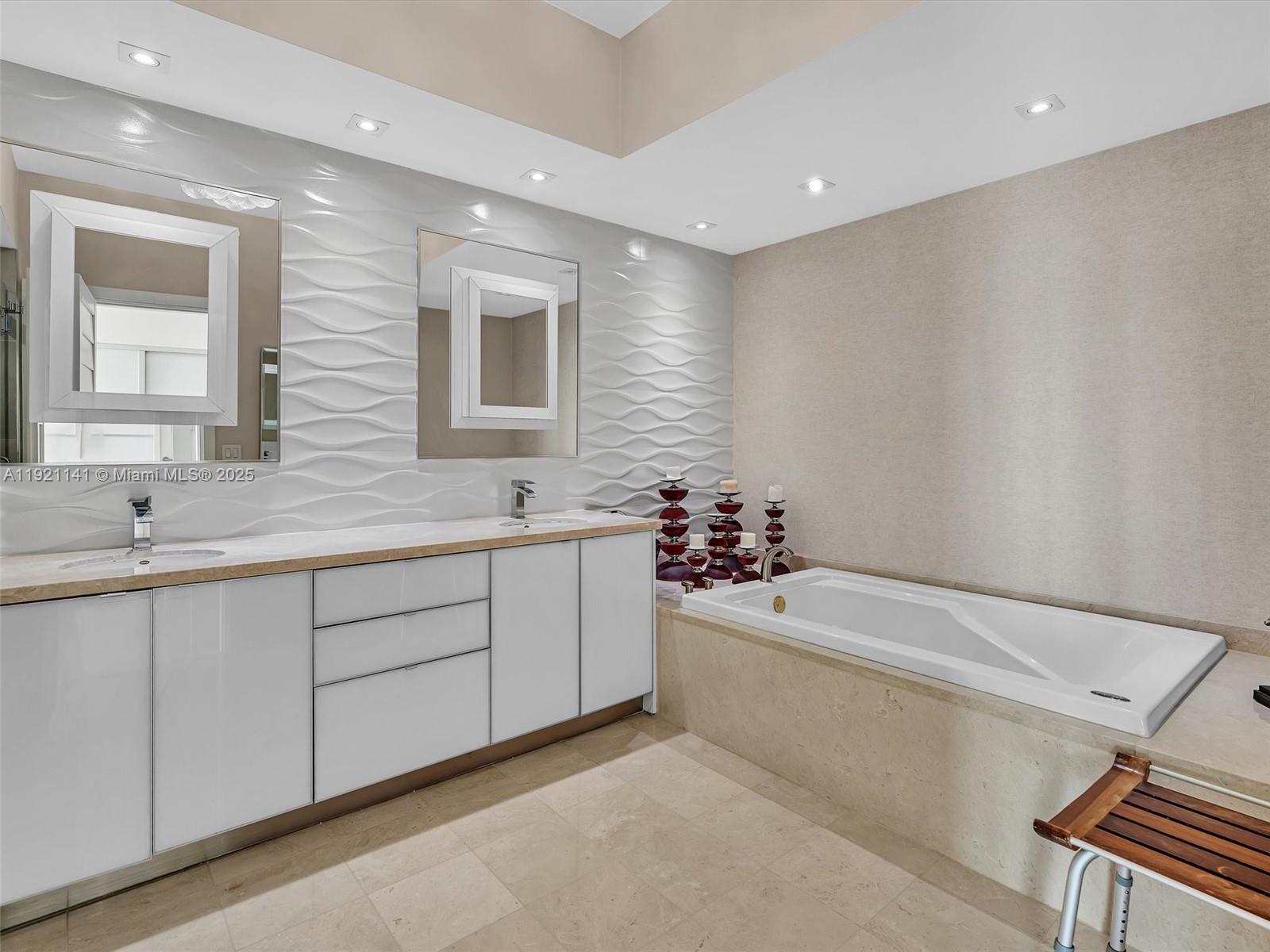 16500 Collins Avenue, Unit PH54 Sunny Isles Beach, FL 33160 - Photo 61 of 97 a spacious bathroom with a double vanity sink a mirror and a bathtub