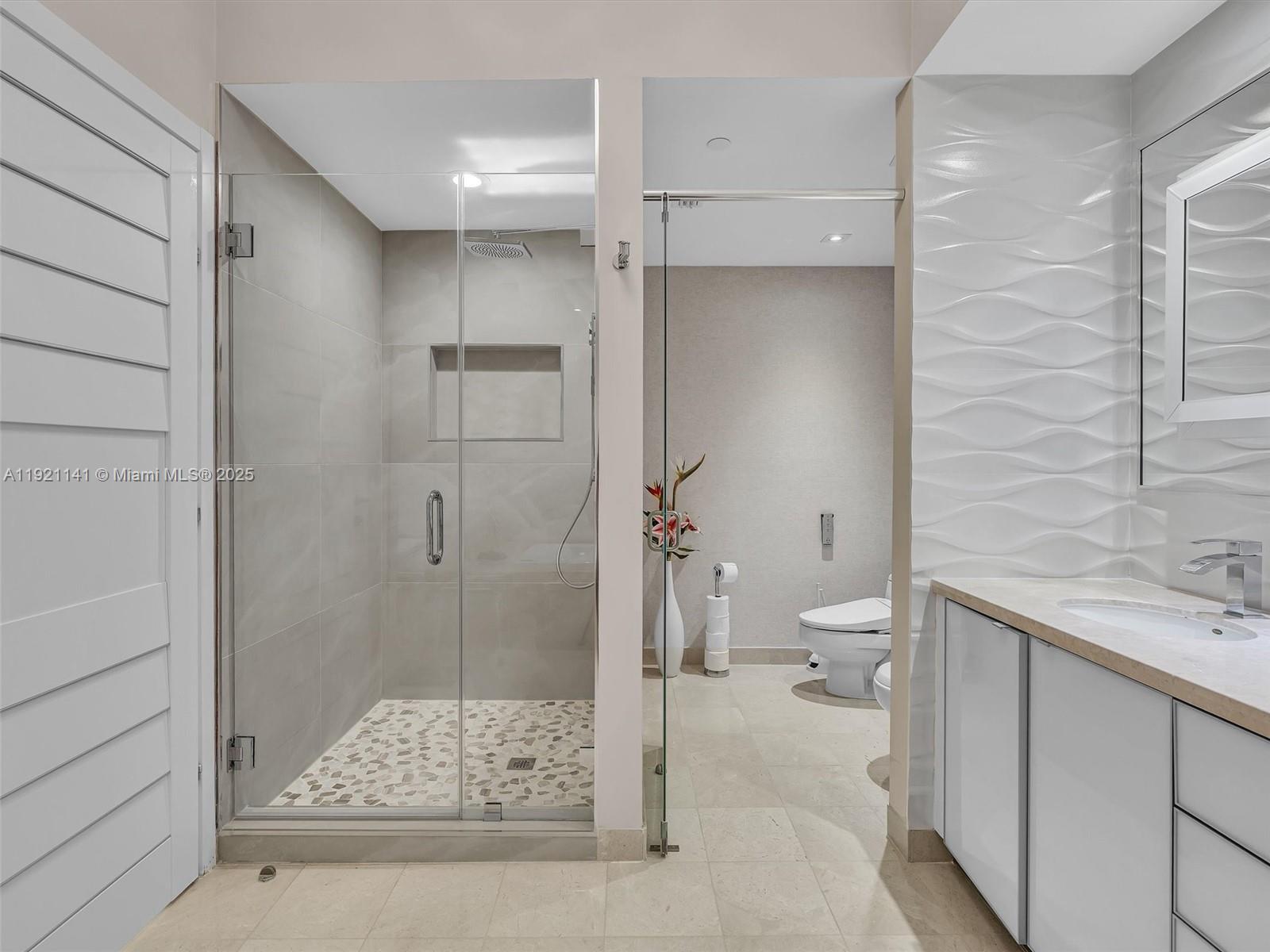 16500 Collins Avenue, Unit PH54 Sunny Isles Beach, FL 33160 - Photo 62 of 97 a bathroom with a granite countertop sink a toilet and shower