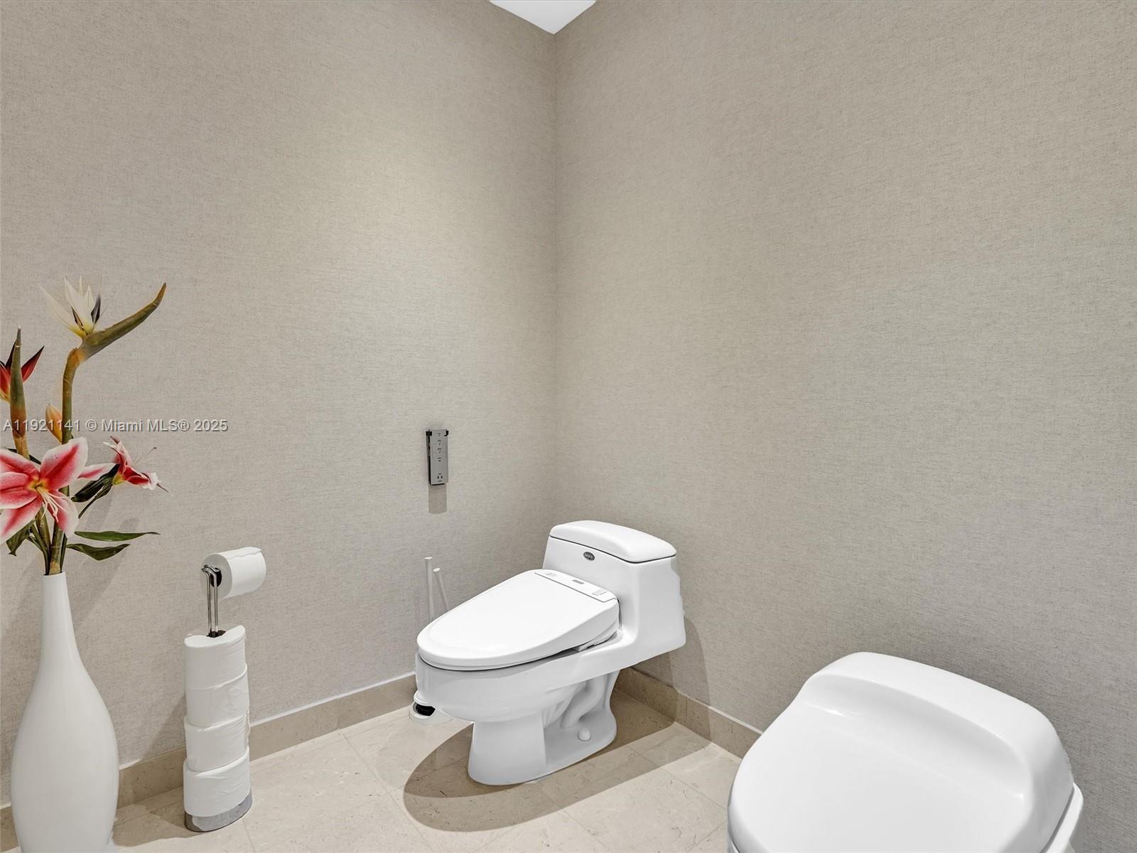 16500 Collins Avenue, Unit PH54 Sunny Isles Beach, FL 33160 - Photo 63 of 97 a white toilet sitting next to a white tub