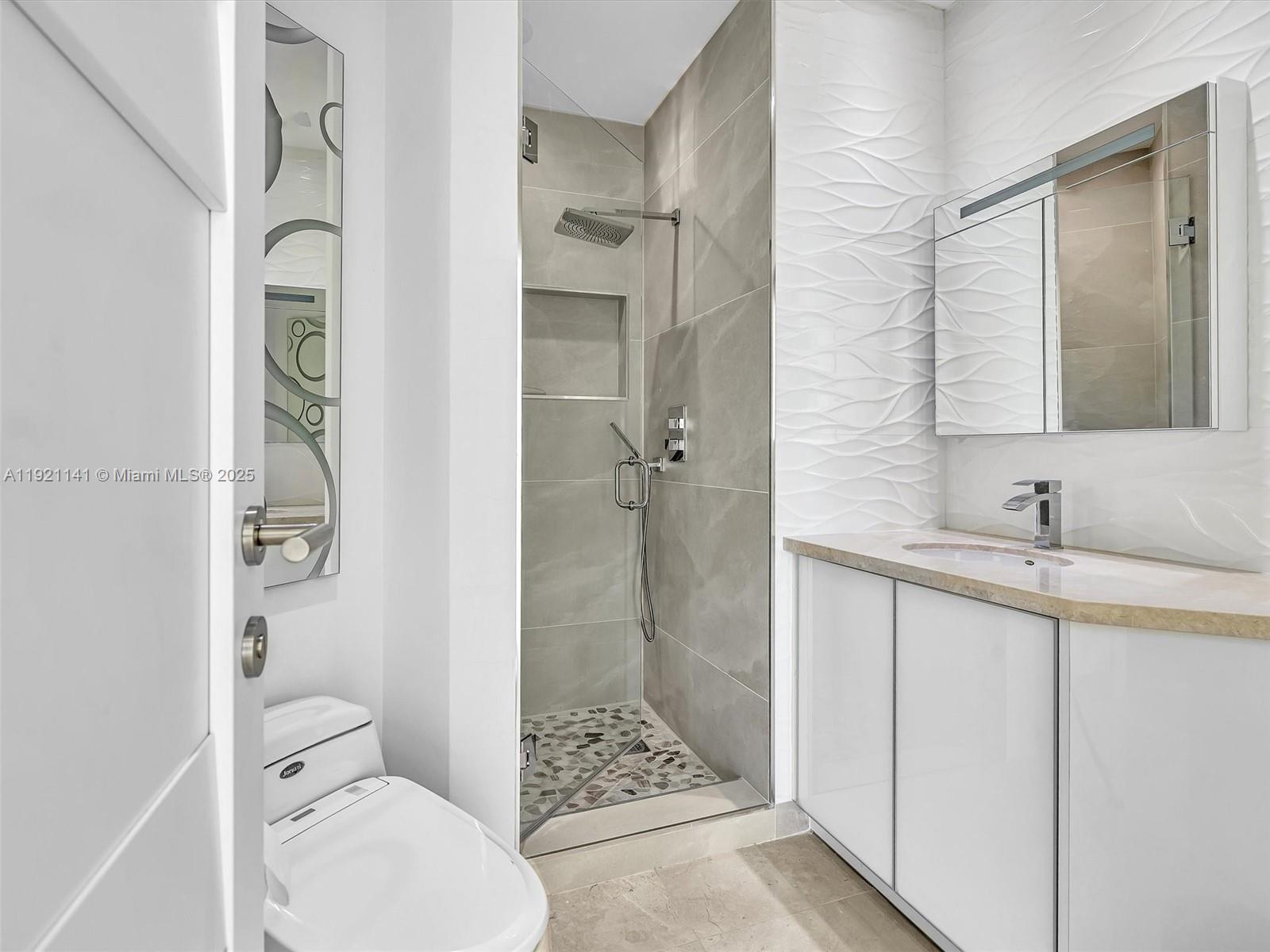 16500 Collins Avenue, Unit PH54 Sunny Isles Beach, FL 33160 - Photo 71 of 97 a bathroom with a granite countertop sink toilet and shower