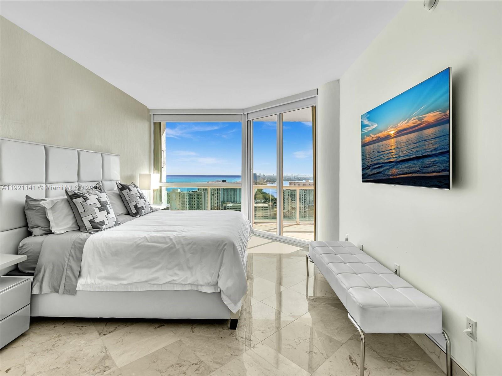 16500 Collins Avenue, Unit PH54 Sunny Isles Beach, FL 33160 - Photo 72 of 97 a bedroom with a bed and a couch