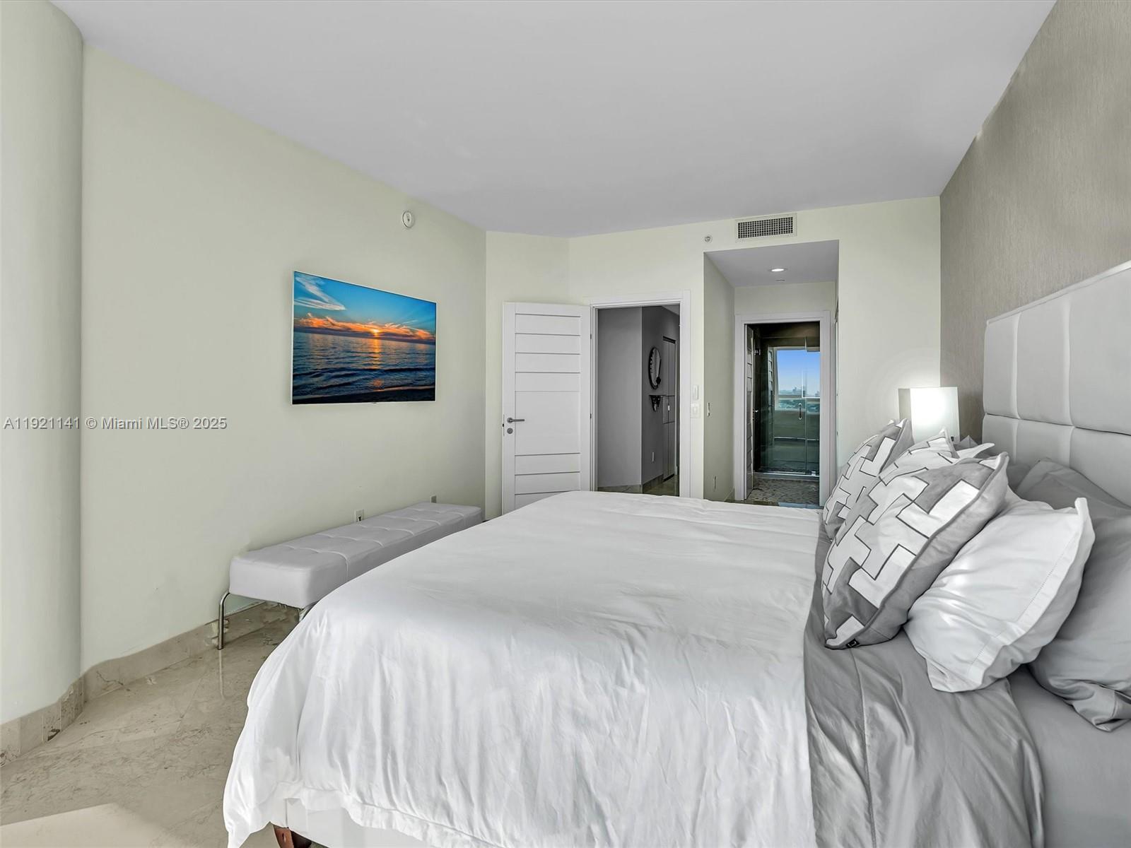 16500 Collins Avenue, Unit PH54 Sunny Isles Beach, FL 33160 - Photo 76 of 97 a bedroom with a bed and a painting on the wall