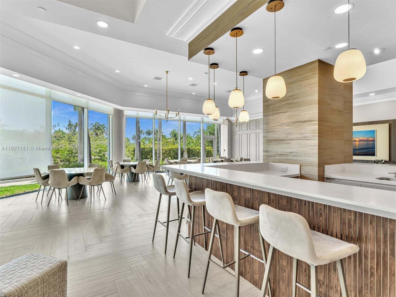 16500 Collins Avenue, Unit PH54 Sunny Isles Beach, FL 33160 - Photo 86 of 97 a large kitchen with a table and chairs