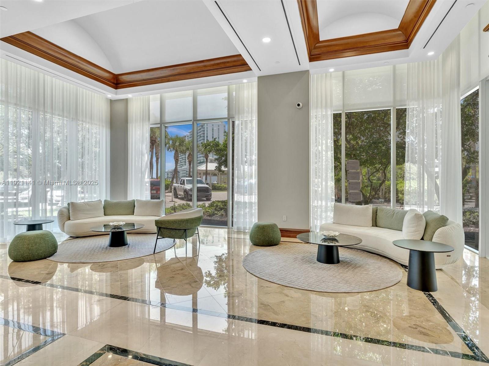 16500 Collins Avenue, Unit PH54 Sunny Isles Beach, FL 33160 - Photo 93 of 97 a living room with furniture and large windows