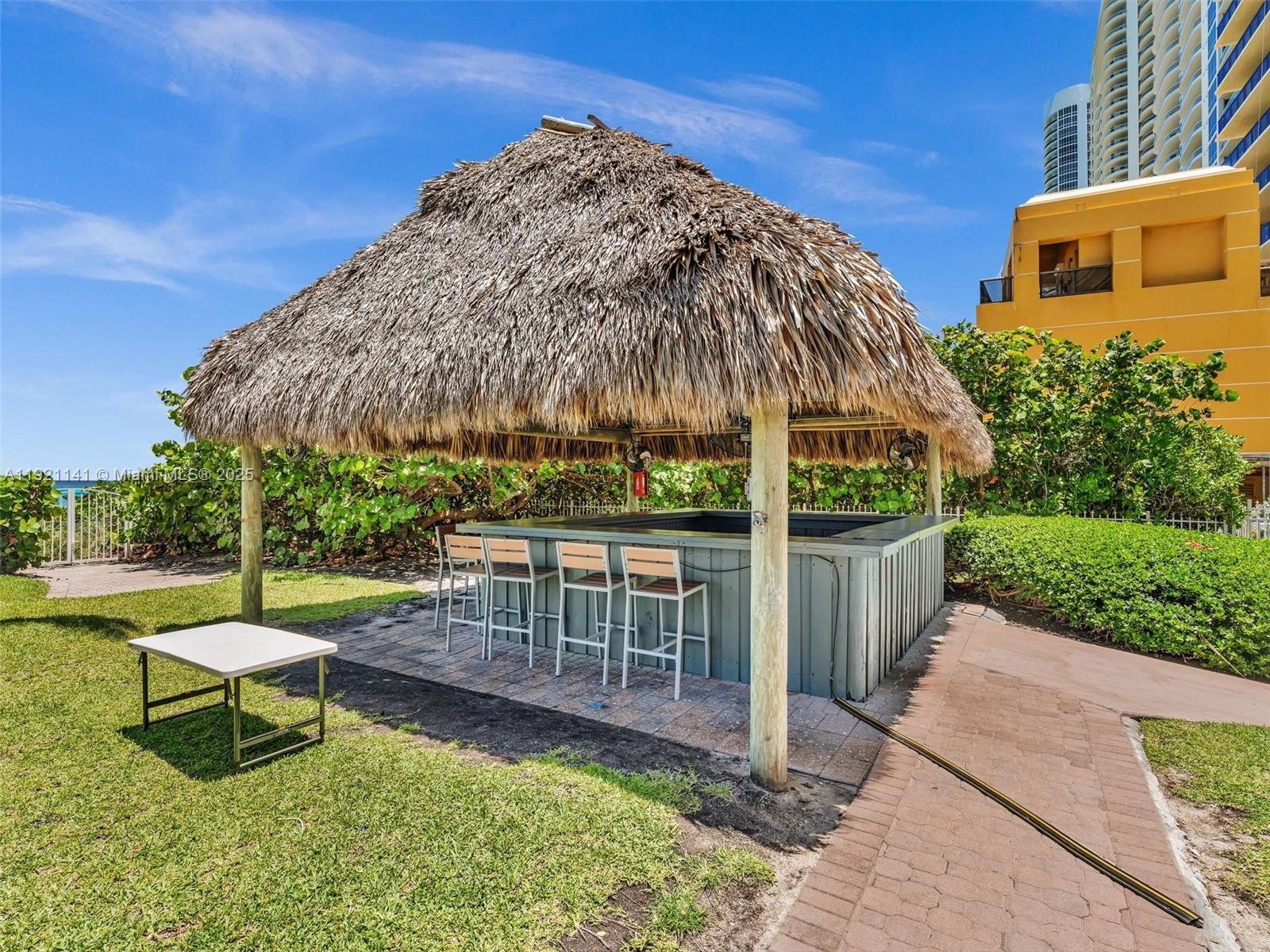 16500 Collins Avenue, Unit PH54 Sunny Isles Beach, FL 33160 - Photo 97 of 97 a view of a chairs and table in backyard of the house