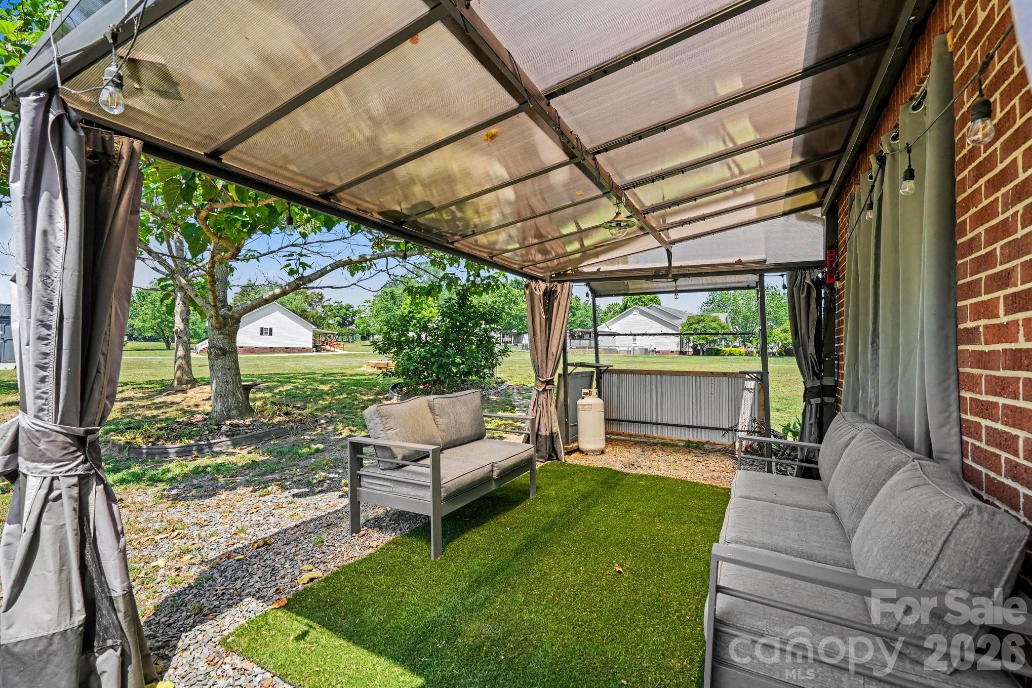 24359 Ridgecrest Road Locust, NC 28097 - Photo 2 of 26 a view of a couches in patio and a yard