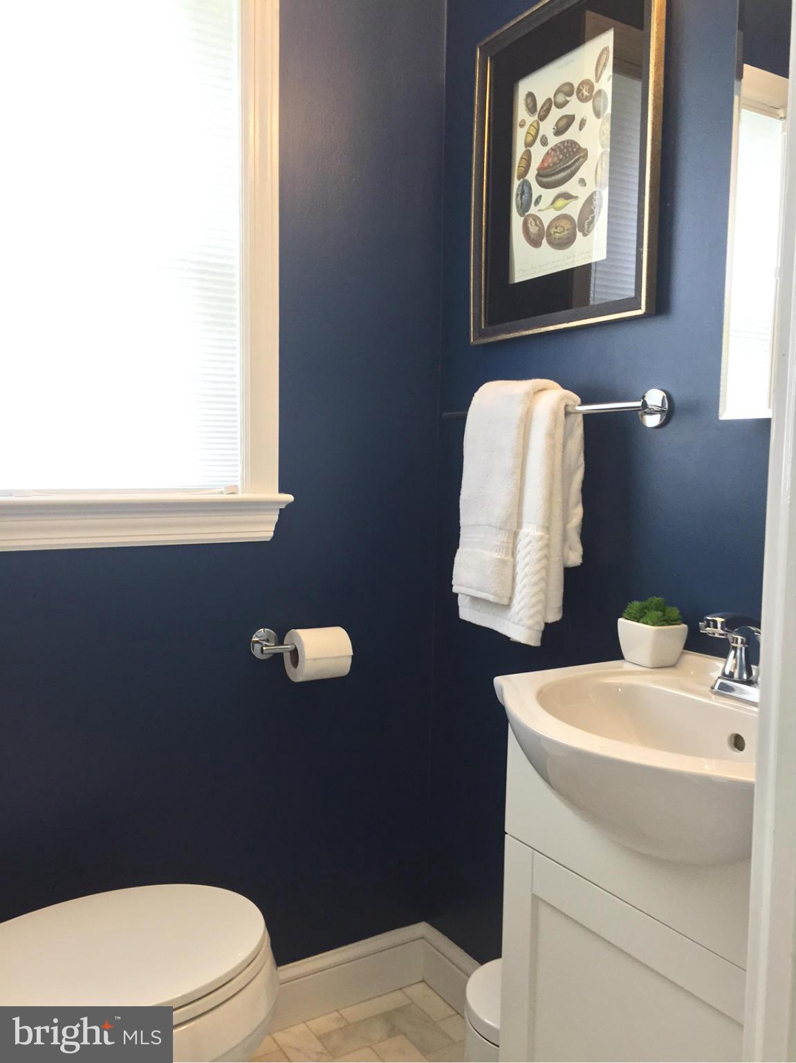 6001 Conway Road Bethesda, MD 20817 - Photo 11 of 26 a bathroom with a sink mirror and toilet