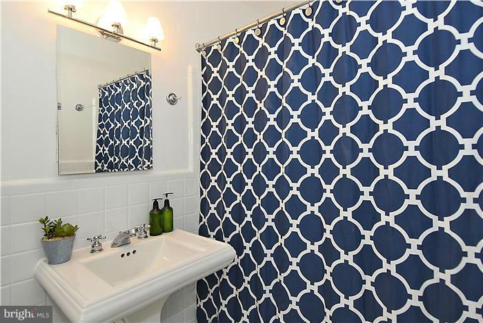 6001 Conway Road Bethesda, MD 20817 - Photo 19 of 26 a bathroom with a sink and a mirror