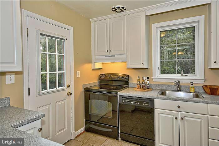 6001 Conway Road Bethesda, MD 20817 - Photo 8 of 26 a kitchen with a stove a sink and a cabinets