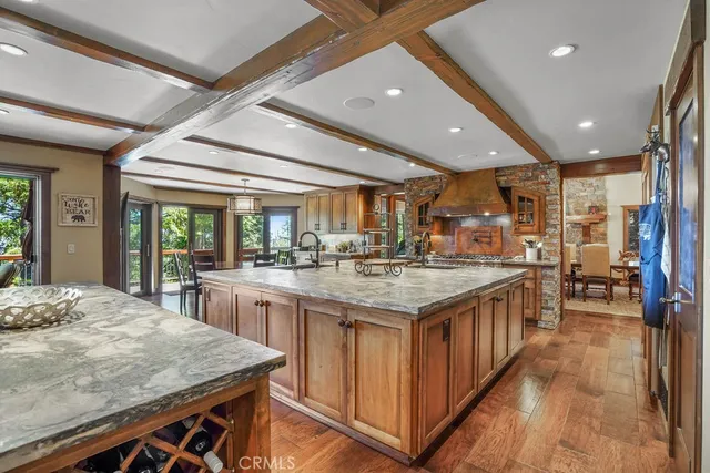 a kitchen with stainless steel appliances kitchen island granite countertop a stove and cabinets