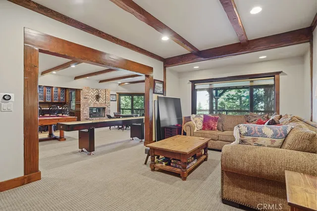 a living room with furniture a fireplace and wall paintings
