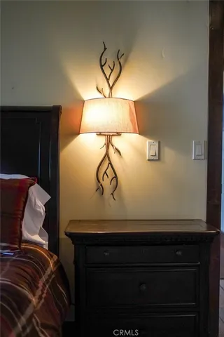 a bedroom with bed couch and window