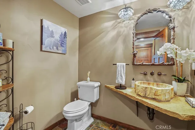 a bathroom with a granite countertop shower a mirror and a shower