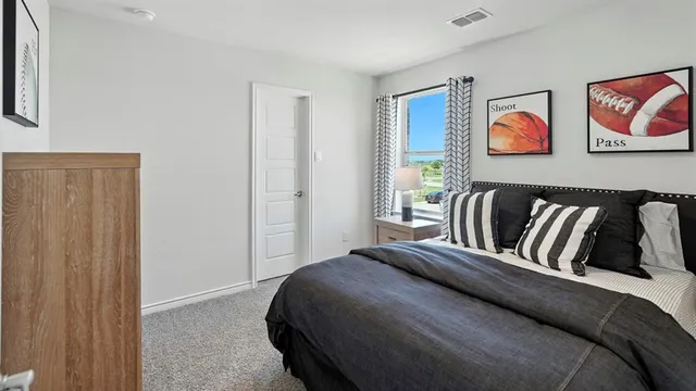 a bedroom with a bed and painting on the wall