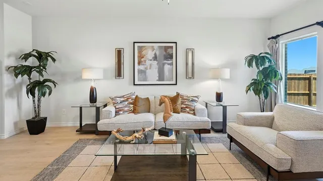 a living room with furniture and a potted plant