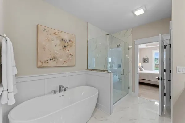 a spacious bathroom with a tub shower and sink