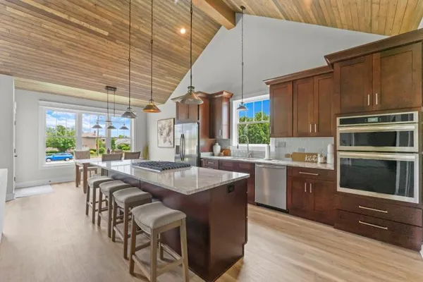 a kitchen with a stove a sink and a refrigerator