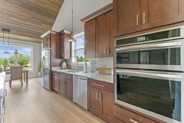 a kitchen with stainless steel appliances kitchen island granite countertop a stove a sink and a microwave