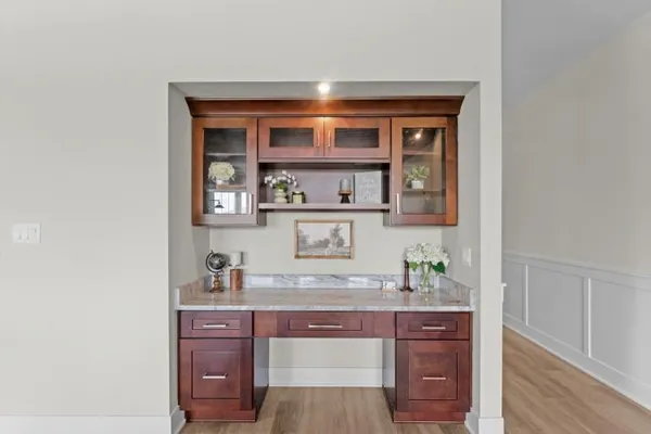 a room with granite countertop cabinets and wooden floor
