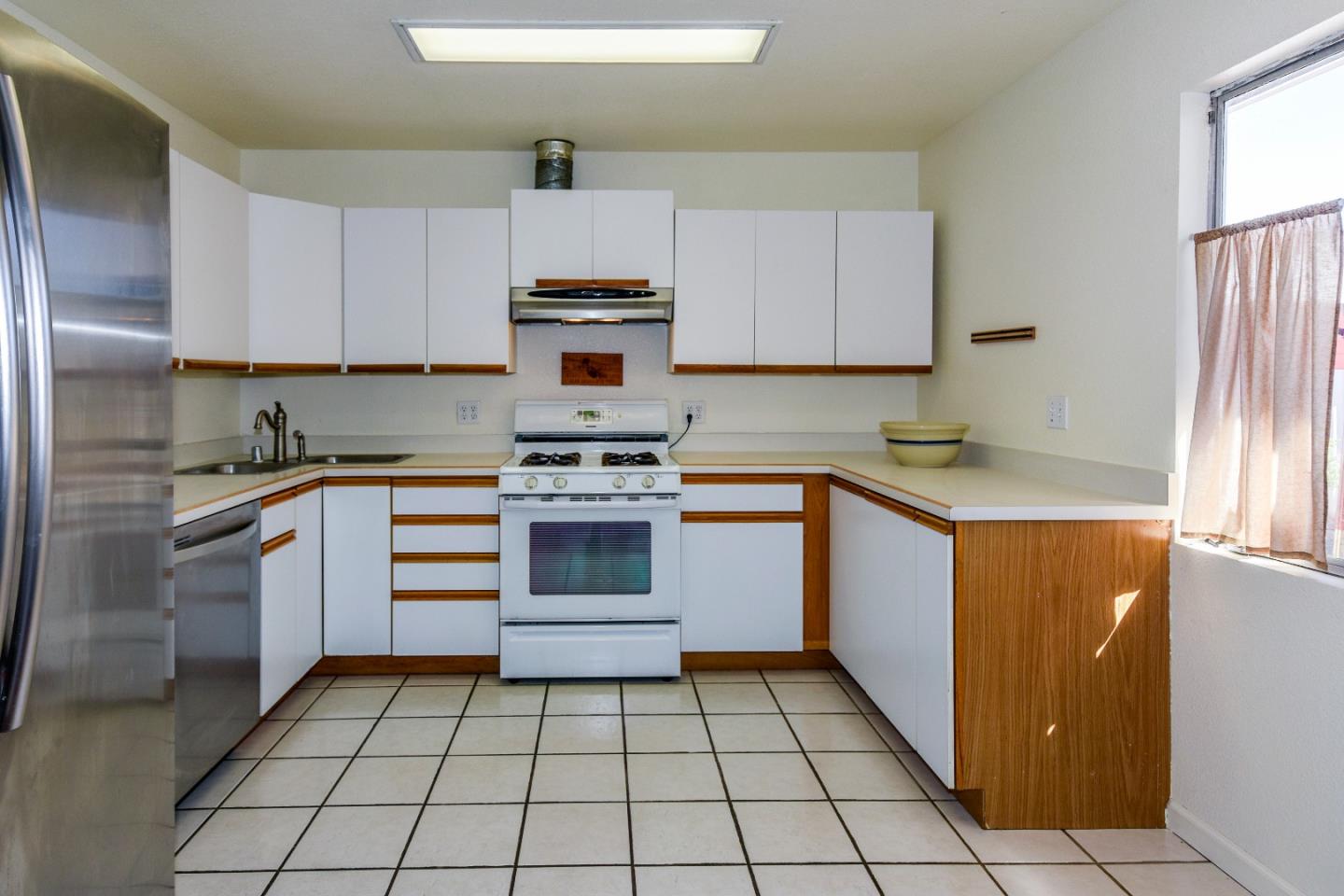 305 Roxas Street Santa Cruz, CA 95062 - Photo 15 of 42 a kitchen with a stove a sink and a refrigerator