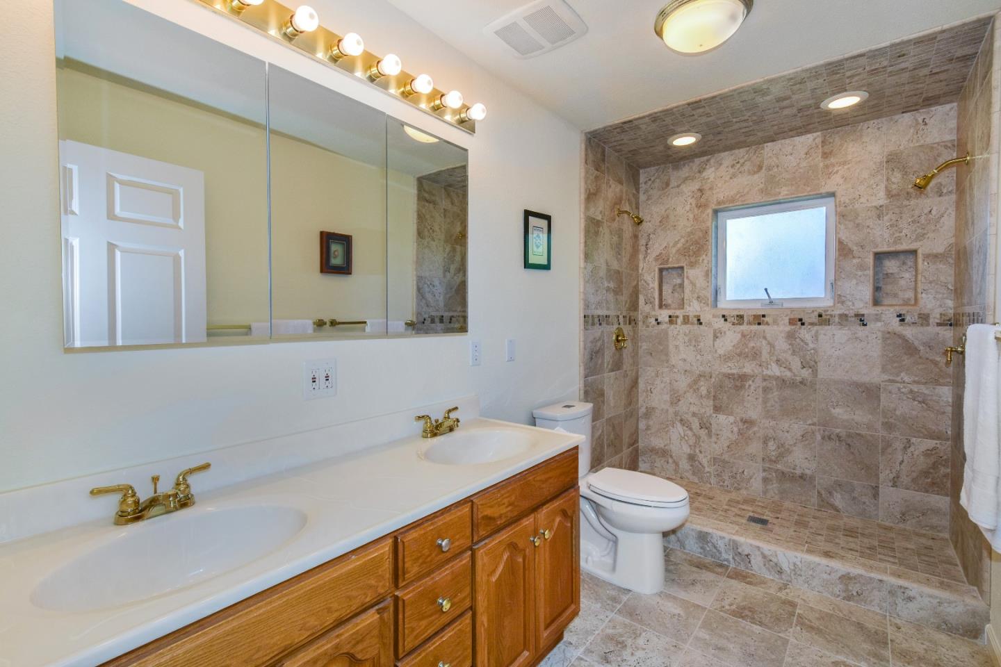 305 Roxas Street Santa Cruz, CA 95062 - Photo 19 of 42 a bathroom with a sink a toilet and shower