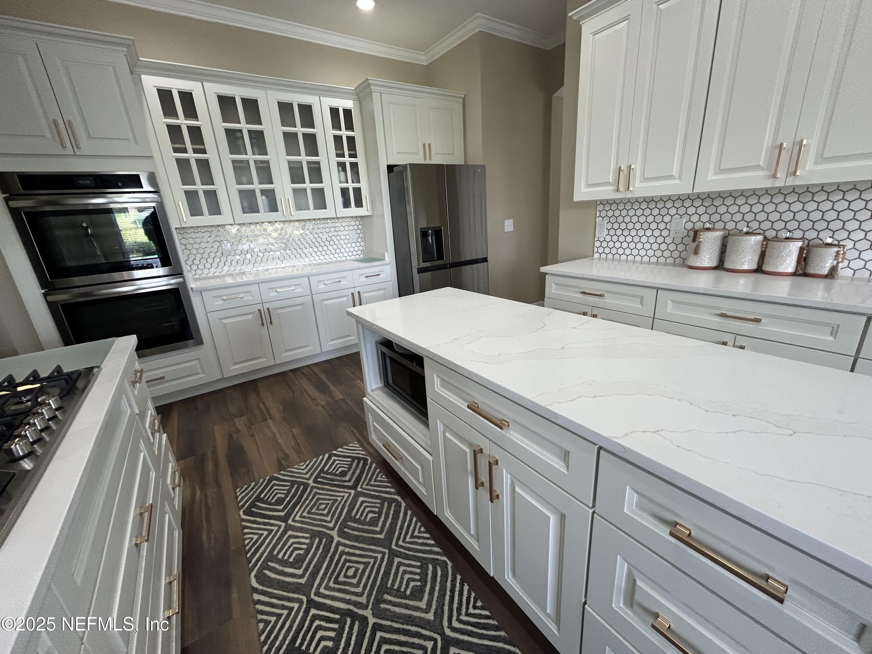 1764 Eagle Watch Drive Fleming Island, FL 32003 - Photo 13 of 41 a kitchen with granite countertop a stove and a refrigerator