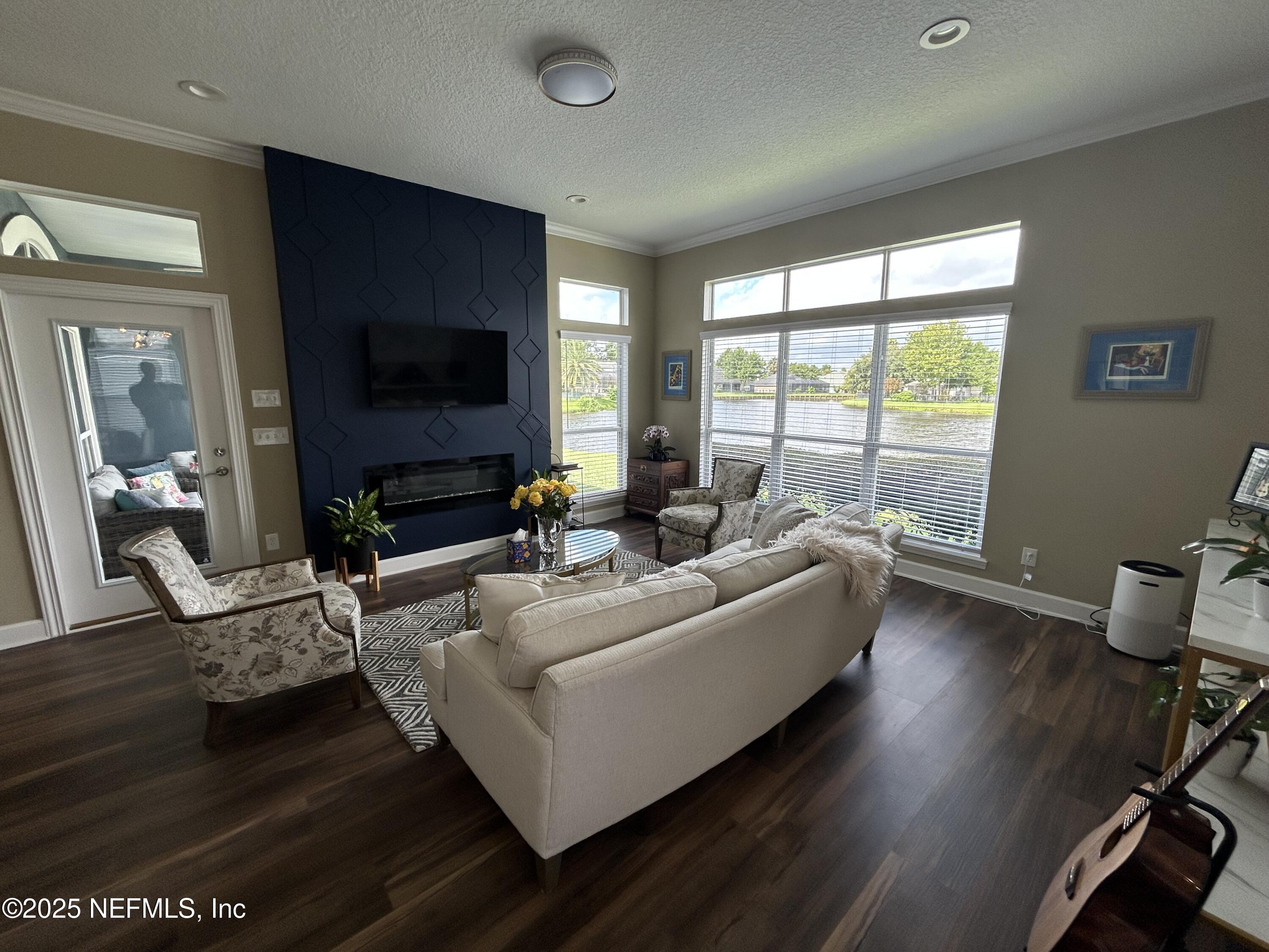 1764 Eagle Watch Drive Fleming Island, FL 32003 - Photo 16 of 41 a living room with furniture and a flat screen tv