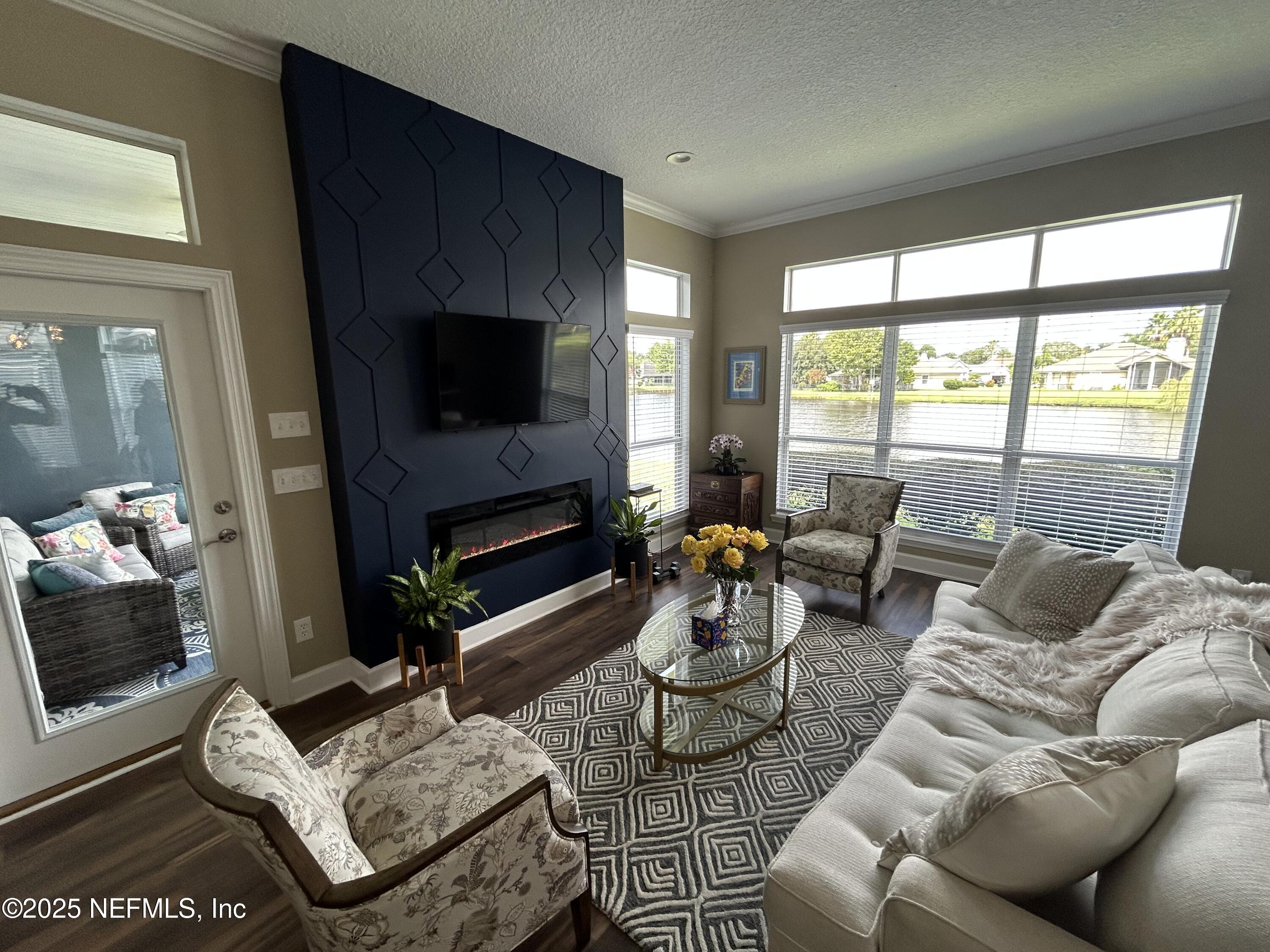 1764 Eagle Watch Drive Fleming Island, FL 32003 - Photo 17 of 41 a living room with furniture a flat screen tv and a fireplace