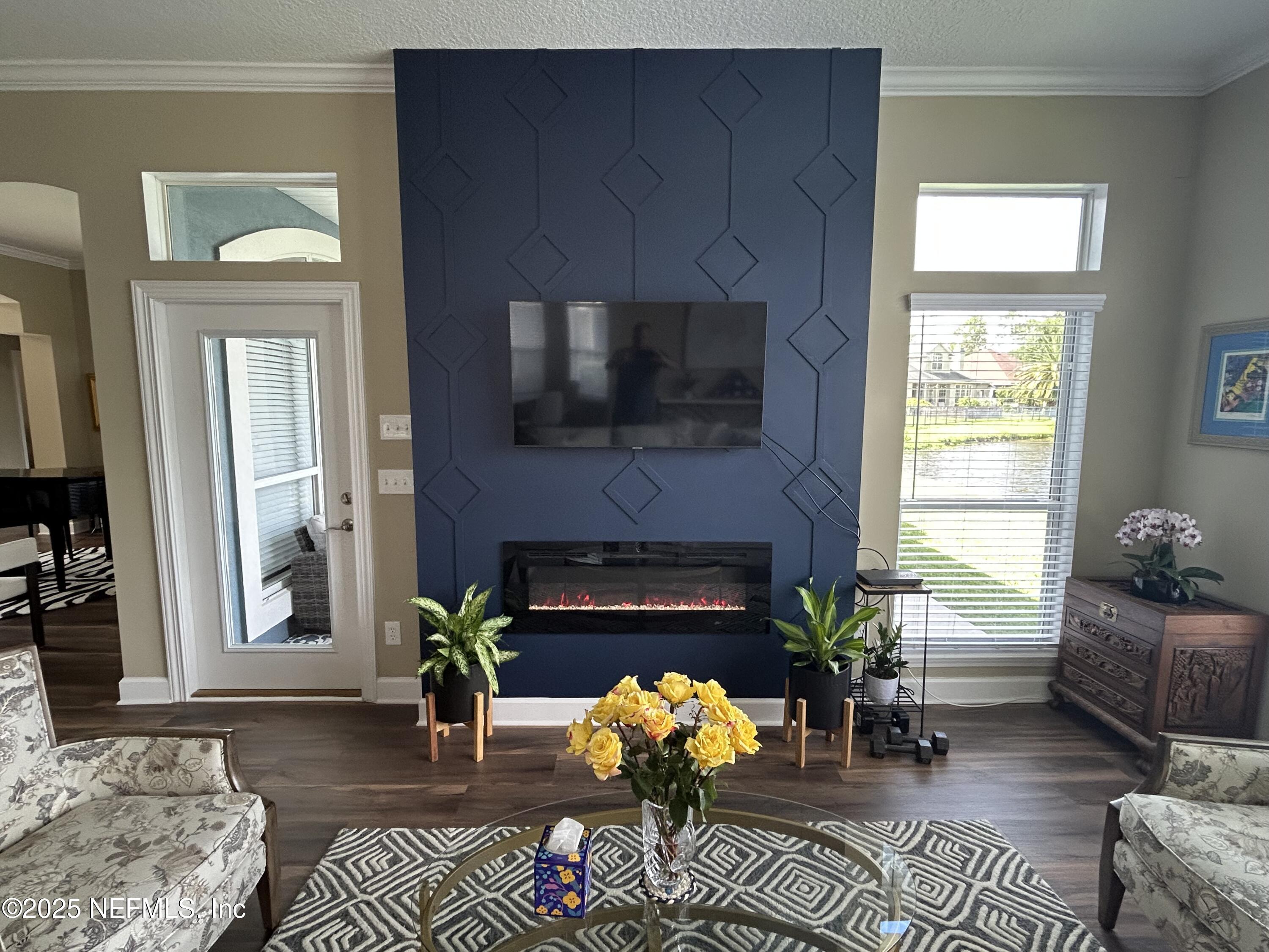 1764 Eagle Watch Drive Fleming Island, FL 32003 - Photo 18 of 41 a living room with furniture a flat screen tv and a fireplace