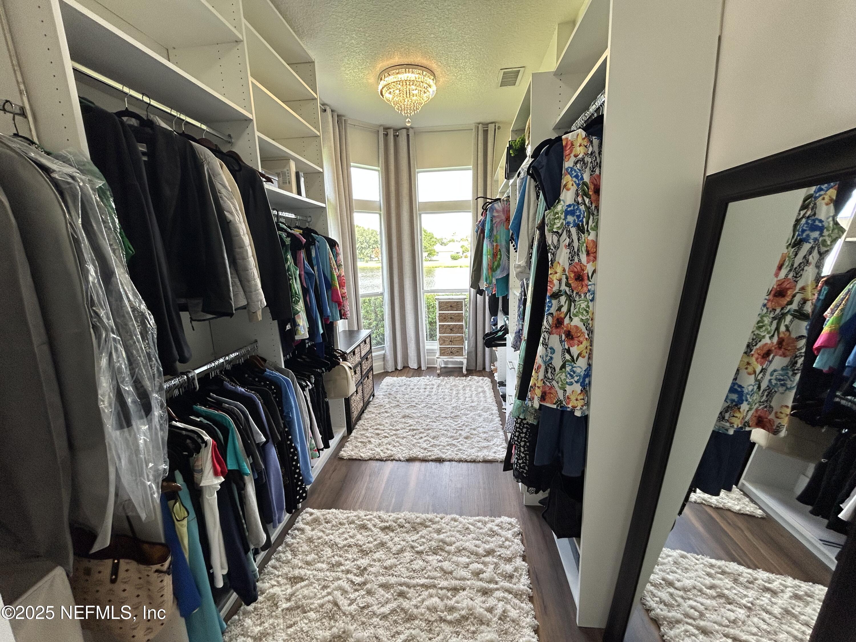 1764 Eagle Watch Drive Fleming Island, FL 32003 - Photo 22 of 41 a view of walk in closet with clothes and shoes