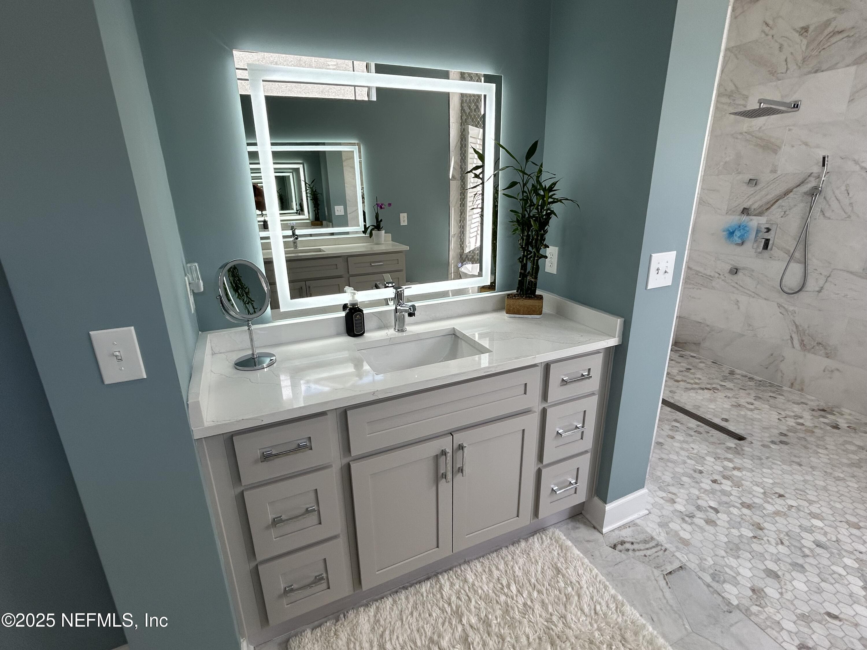 1764 Eagle Watch Drive Fleming Island, FL 32003 - Photo 25 of 41 a bathroom with a double vanity sink and mirror