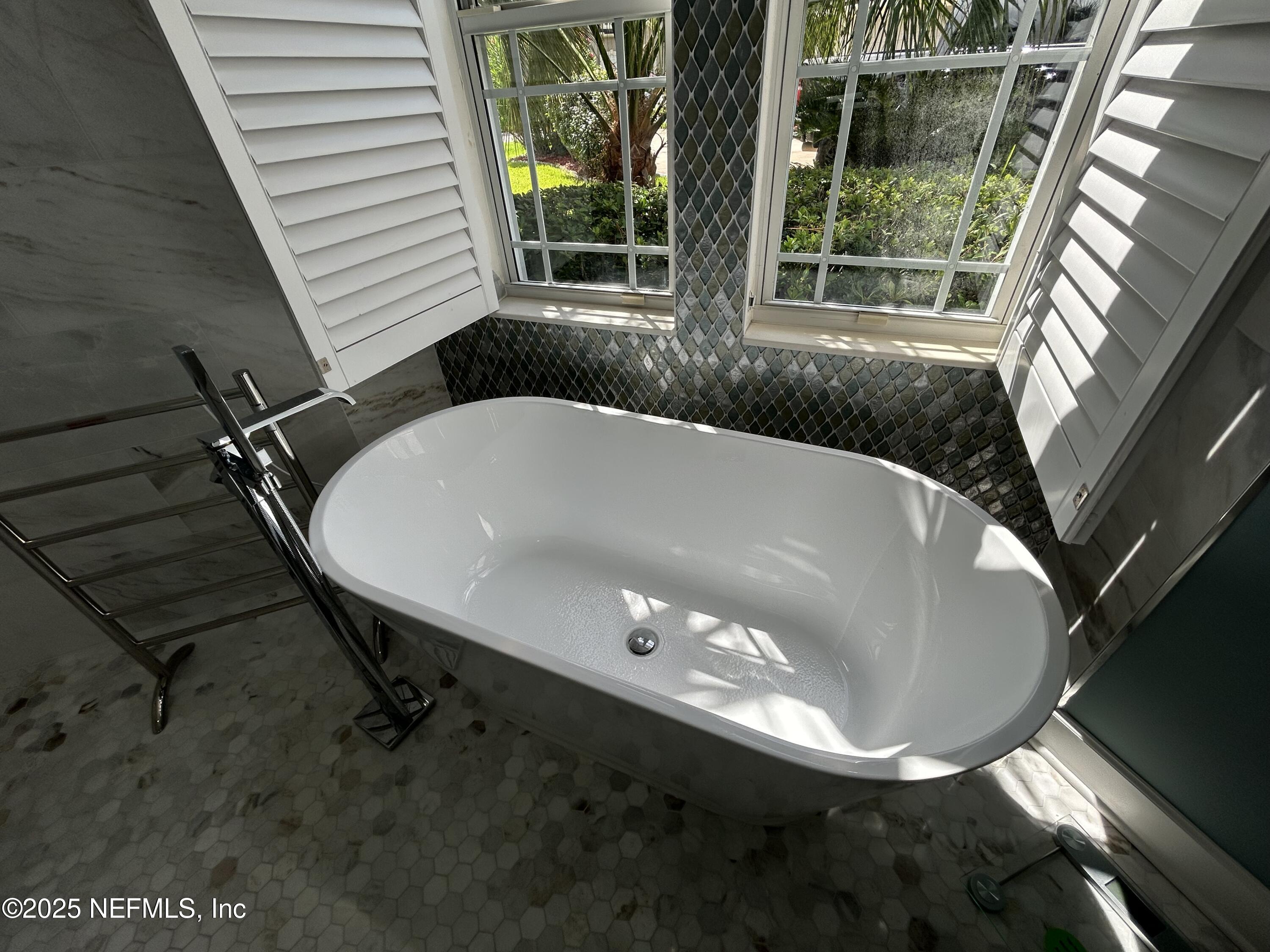 1764 Eagle Watch Drive Fleming Island, FL 32003 - Photo 27 of 41 a bathroom with a bathtub and a window