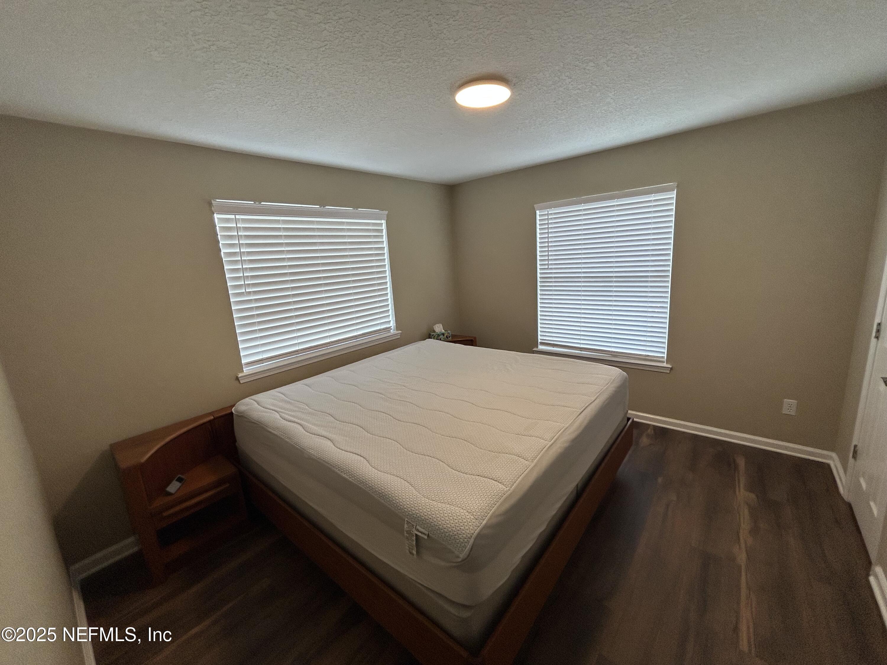 1764 Eagle Watch Drive Fleming Island, FL 32003 - Photo 34 of 41 a bed sitting in a bedroom next to a window