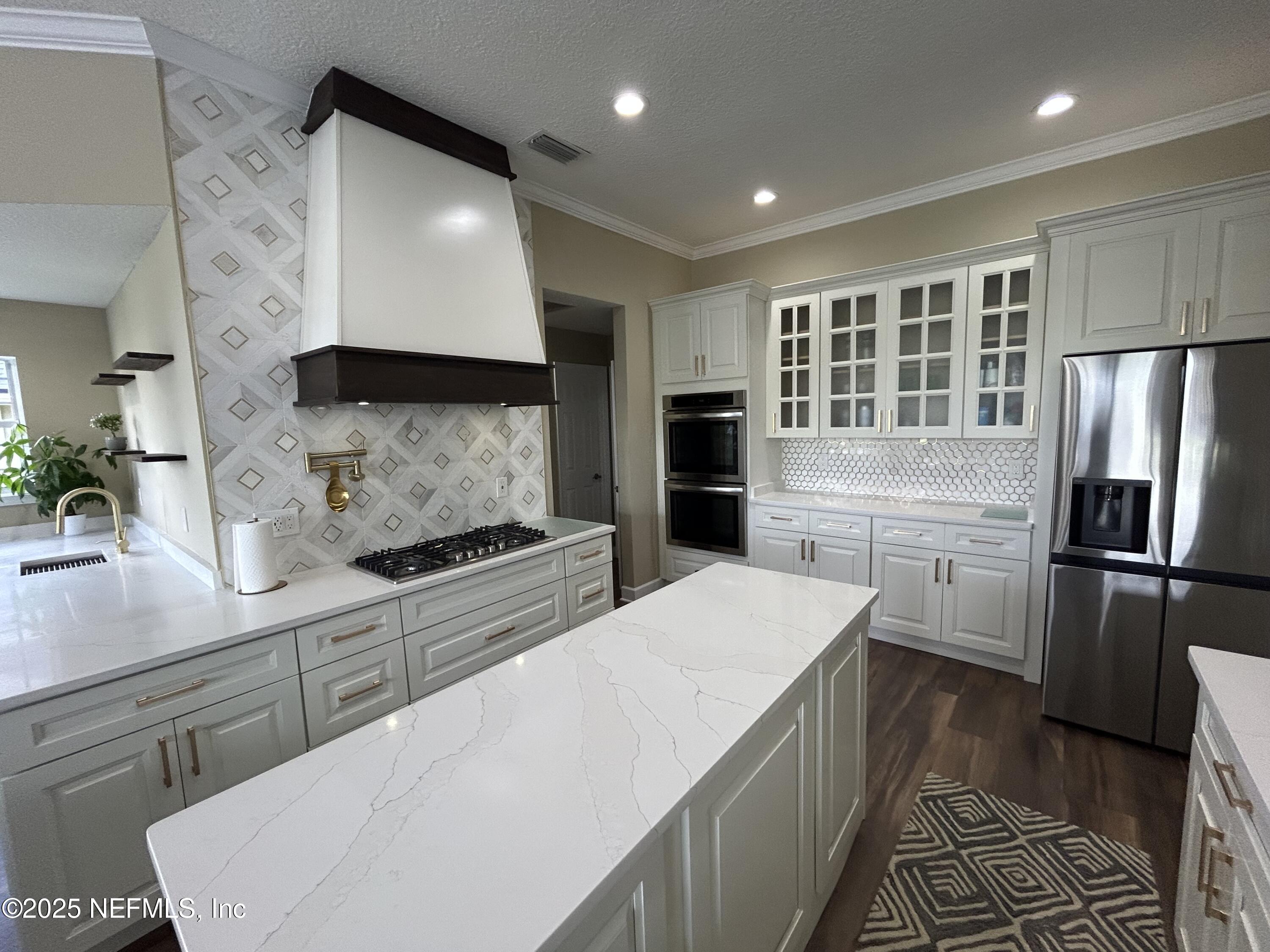 1764 Eagle Watch Drive Fleming Island, FL 32003 - Photo 6 of 41 a kitchen with stainless steel appliances a refrigerator sink and stove