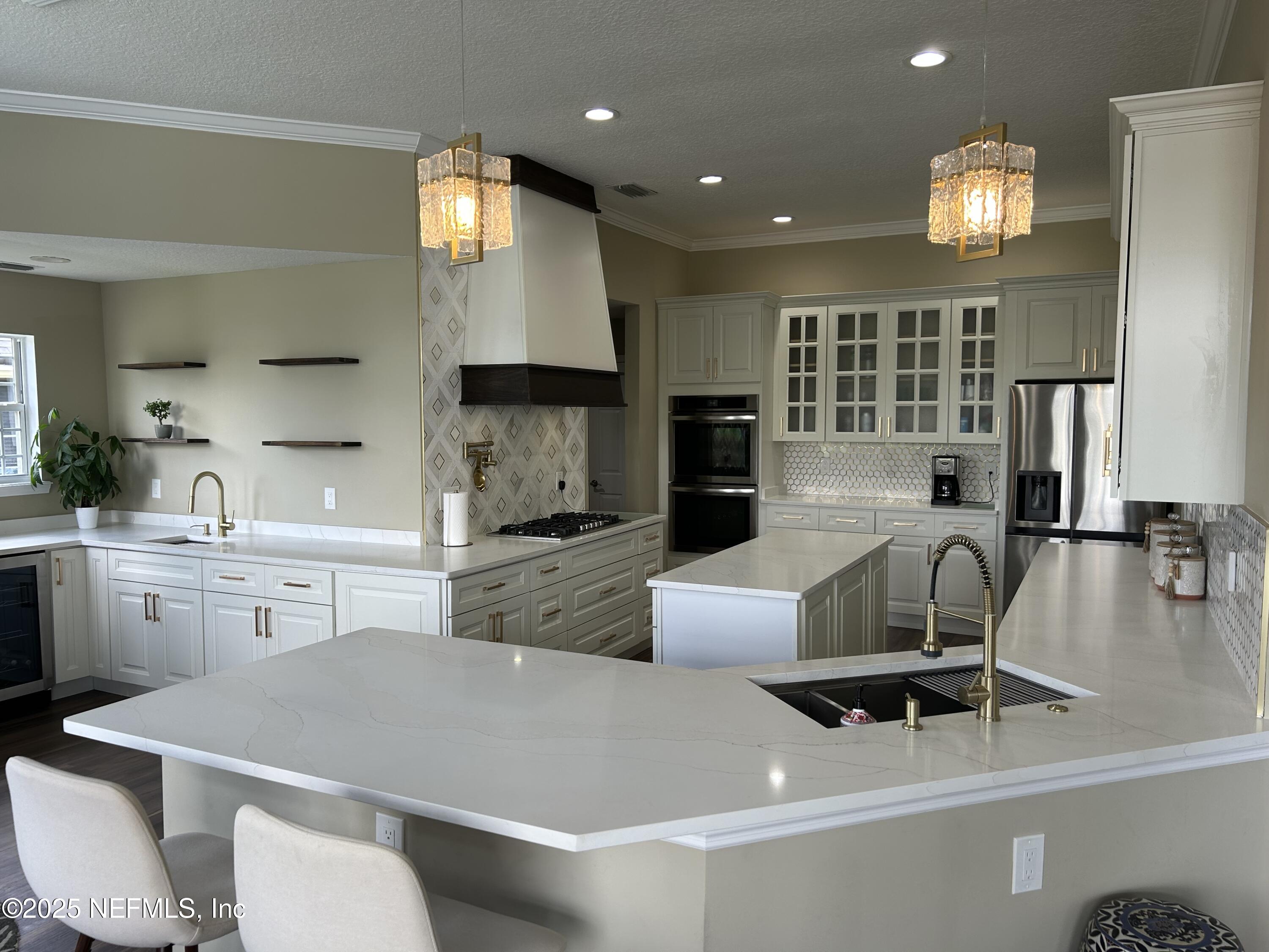 1764 Eagle Watch Drive Fleming Island, FL 32003 - Photo 10 of 41 a living room with furniture a chandelier and kitchen view