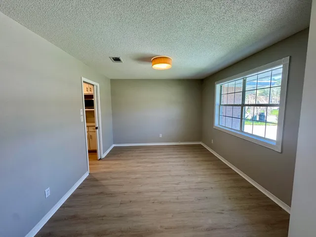 an empty room with windows and entrance