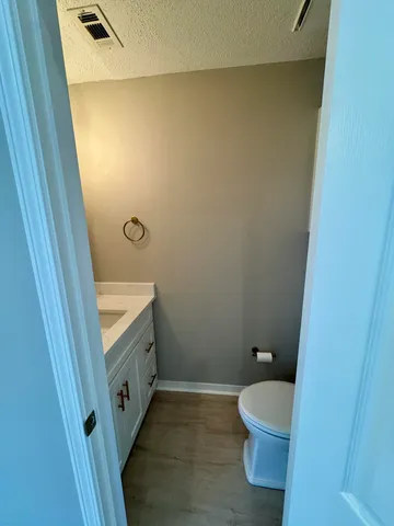 a view of a room with wooden floor and sink