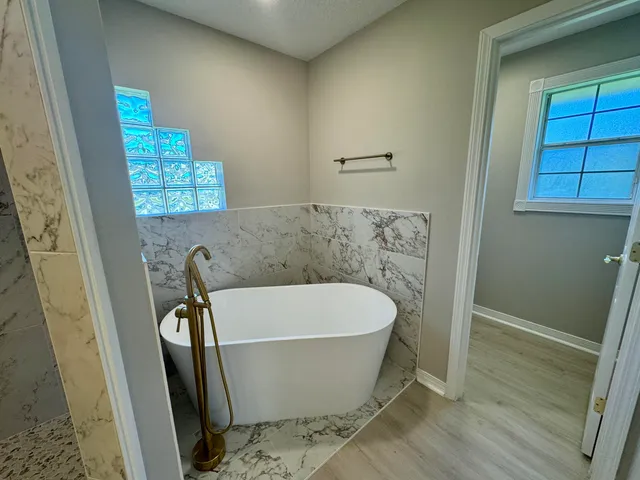 a white bath tub sitting in a bathroom