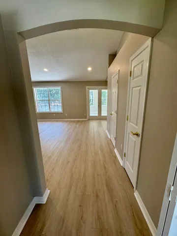 a view of a room with wooden floor and staircase